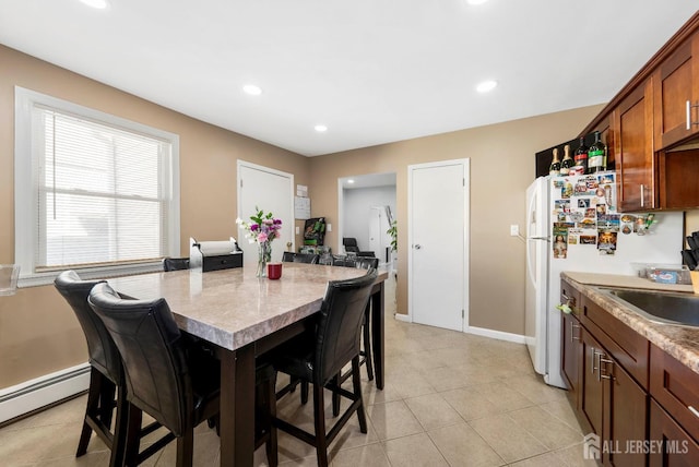 dining area with recessed lighting, a baseboard heating unit, baseboards, and light tile patterned flooring