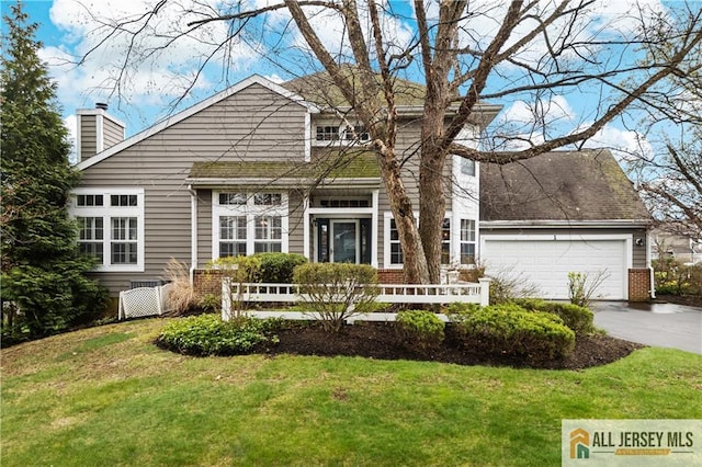 1 Eagle Ct, Monroe, NJ 08831 - view of front of house with concrete driveway, brick siding, a chimney, and a front yard