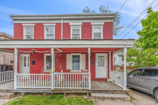 view of front of property with brick siding and covered porch