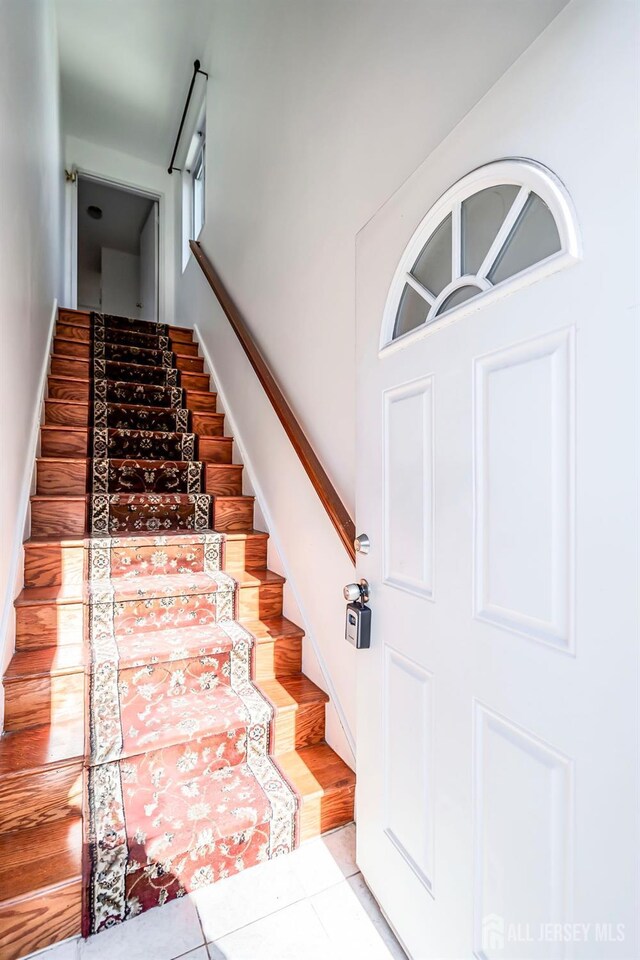 stairs featuring tile patterned flooring