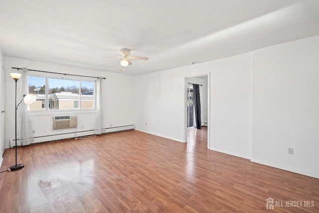 unfurnished room featuring baseboard heating, hardwood / wood-style floors, ceiling fan, and a wall mounted AC