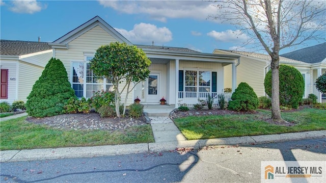 view of front of home with a front yard and a porch