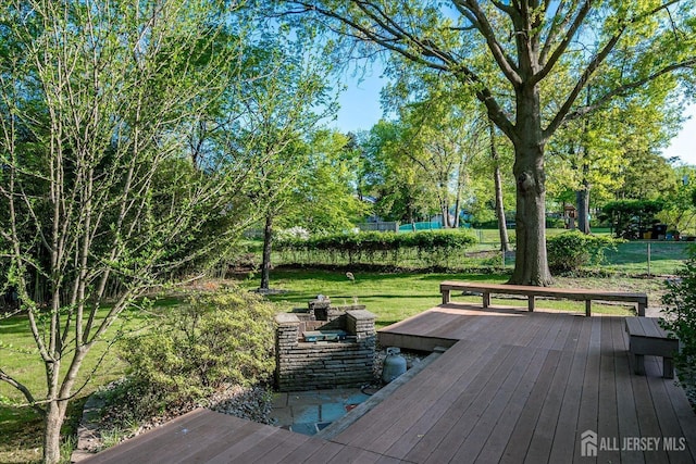 12 Sherry Rd, East Brunswick, NJ 08816 - deck featuring a lawn, a fire pit, and view of scattered trees