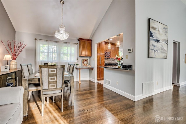 12 Sherry Rd, East Brunswick, NJ 08816 - dining room with a chandelier, dark wood-style flooring, vaulted ceiling, and baseboards