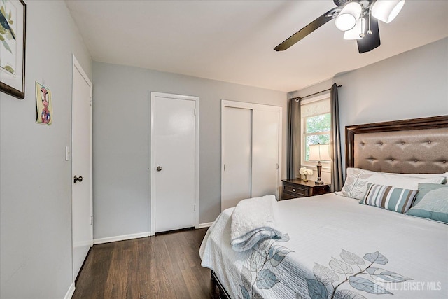 bedroom with dark wood-style floors, baseboards, and ceiling fan
