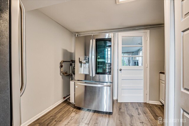 12 Sherry Rd, East Brunswick, NJ 08816 - kitchen featuring stainless steel fridge with ice dispenser, wood finished floors, and baseboards