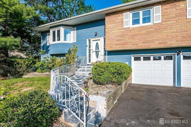 12 Sherry Rd, East Brunswick, NJ 08816 - split foyer home featuring an attached garage and asphalt driveway