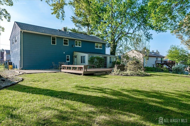 12 Sherry Rd, East Brunswick, NJ 08816 - rear view of house featuring a wooden deck, a lawn, and a chimney