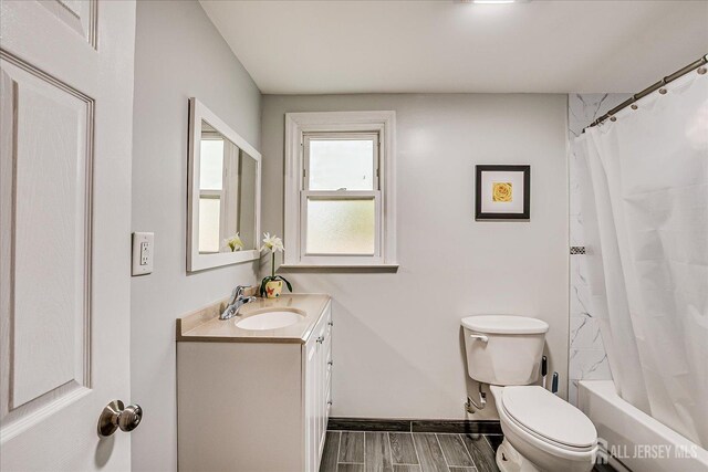 12 Sherry Rd, East Brunswick, NJ 08816 - full bathroom featuring vanity, toilet, baseboards, wood tiled floors, and shower / bath combo