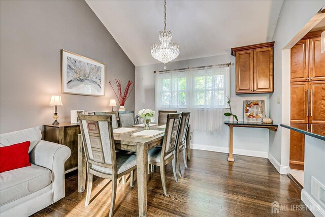 12 Sherry Rd, East Brunswick, NJ 08816 - dining space with lofted ceiling, a chandelier, dark wood-style flooring, and baseboards