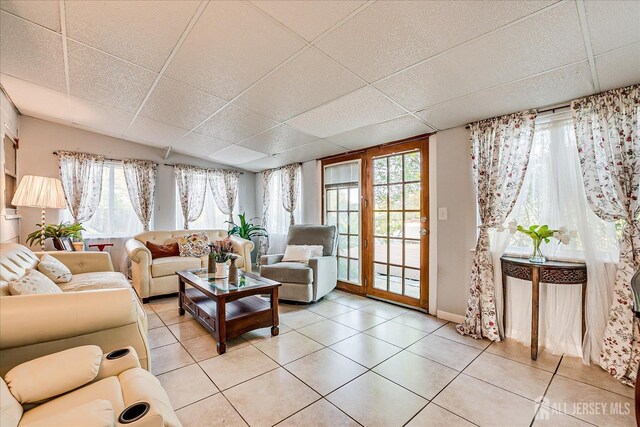 12 Sherry Rd, East Brunswick, NJ 08816 - living area with healthy amount of natural light, light tile patterned floors, a drop ceiling, and baseboards