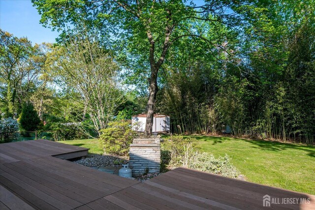12 Sherry Rd, East Brunswick, NJ 08816 - wooden terrace featuring a storage unit, an outbuilding, and a yard