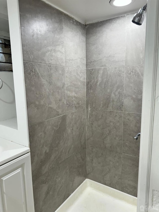 bathroom with a shower stall and vanity