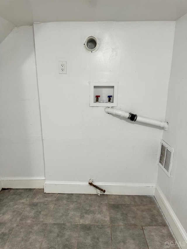 clothes washing area with hookup for a washing machine, laundry area, visible vents, and baseboards