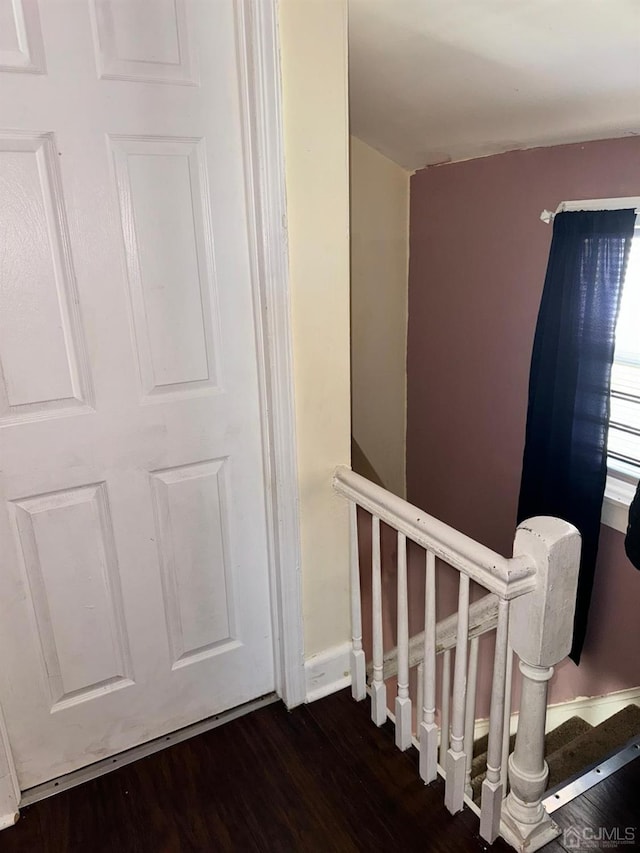 stairs featuring baseboards and wood finished floors