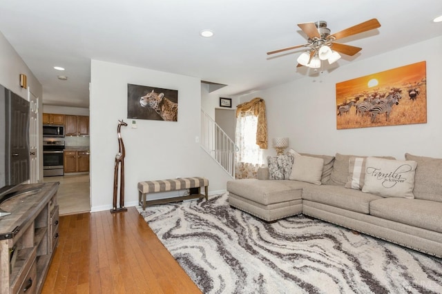 living room featuring ceiling fan and wood-type flooring