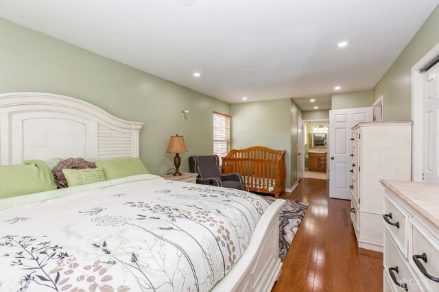 bedroom with dark hardwood / wood-style flooring