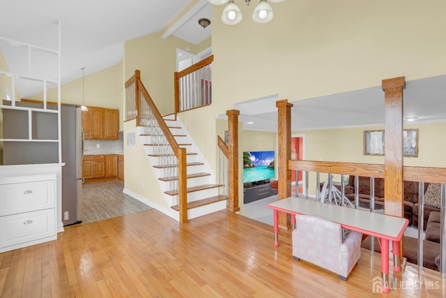 186 Tyler Ave, Iselin, NJ 08830 - living room with high vaulted ceiling, light wood-type flooring, decorative columns, stairs, and beam ceiling