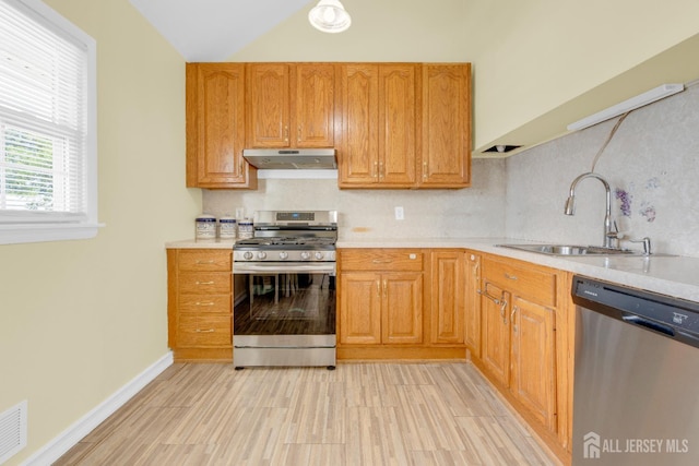 186 Tyler Ave, Iselin, NJ 08830 - kitchen featuring appliances with stainless steel finishes, under cabinet range hood, light countertops, and lofted ceiling