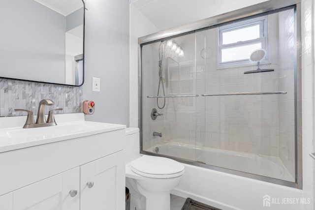 186 Tyler Ave, Iselin, NJ 08830 - full bathroom featuring vanity, combined bath / shower with glass door, backsplash, and crown molding