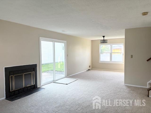 21 Rice Run, East Brunswick, NJ 08816 - unfurnished living room with carpet flooring, baseboards, stairs, and a fireplace with flush hearth