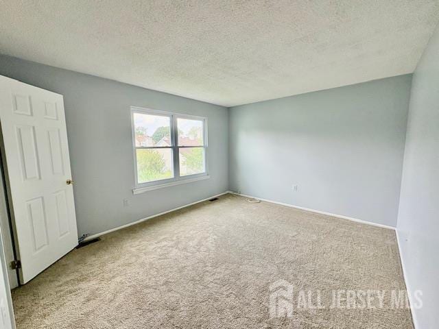 21 Rice Run, East Brunswick, NJ 08816 - empty room featuring carpet, a textured ceiling, and baseboards