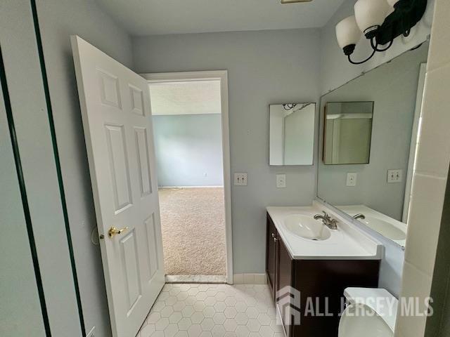 21 Rice Run, East Brunswick, NJ 08816 - bathroom featuring vanity, tile patterned floors, and baseboards