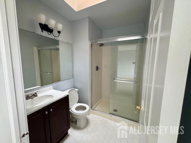 21 Rice Run, East Brunswick, NJ 08816 - full bathroom with toilet, a shower stall, vanity, tile patterned floors, and a skylight