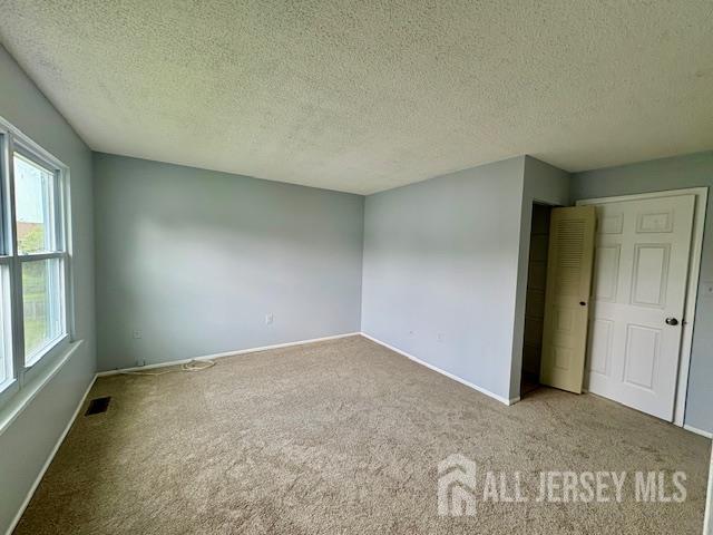 21 Rice Run, East Brunswick, NJ 08816 - carpeted spare room with a textured ceiling