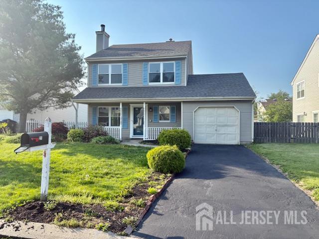 21 Rice Run, East Brunswick, NJ 08816 - traditional-style house featuring a porch, an attached garage, a chimney, and asphalt driveway