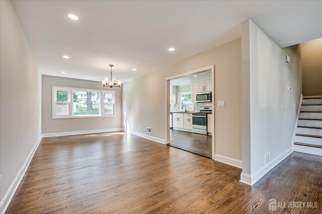 15 Crassas St, Old Bridge, NJ 08879 - spare room featuring a chandelier, dark wood-style flooring, stairs, and recessed lighting