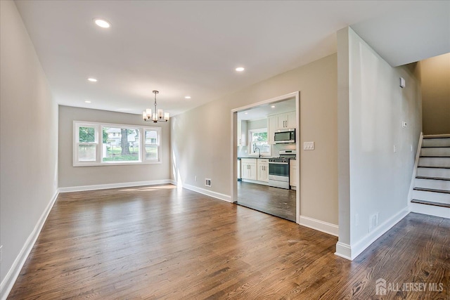 15 Crassas St, Old Bridge, NJ 08879 - spare room featuring a chandelier, dark wood finished floors, stairway, and recessed lighting
