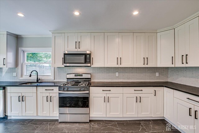 15 Crassas St, Old Bridge, NJ 08879 - kitchen with stainless steel appliances, dark marble finish floors, ornamental molding, dark countertops, and recessed lighting
