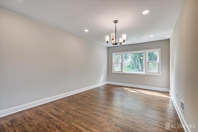 15 Crassas St, Old Bridge, NJ 08879 - empty room with a chandelier, dark wood-type flooring, and recessed lighting