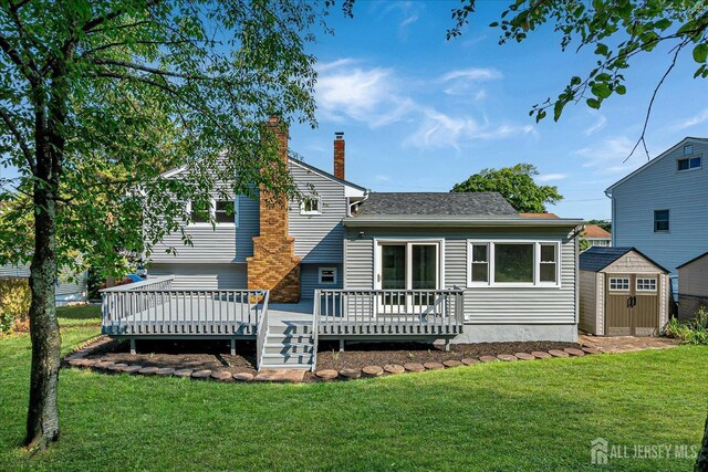 15 Crassas St, Old Bridge, NJ 08879 - rear view of property with a storage unit, a chimney, a wooden deck, and a yard