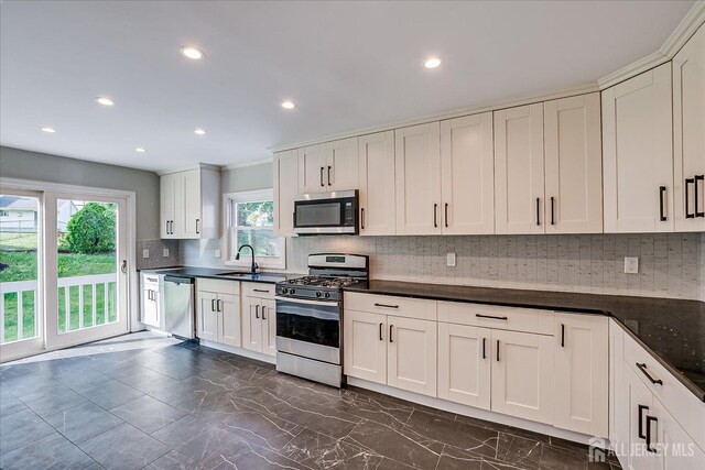 15 Crassas St, Old Bridge, NJ 08879 - kitchen featuring stainless steel appliances, dark countertops, decorative backsplash, recessed lighting, and dark marble finish floors