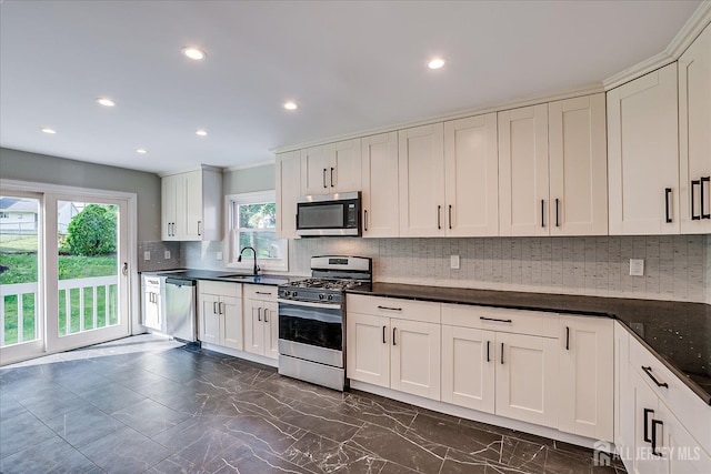 15 Crassas St, Old Bridge, NJ 08879 - kitchen with appliances with stainless steel finishes, dark countertops, tasteful backsplash, recessed lighting, and dark marble finish floors