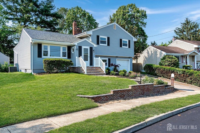 15 Crassas St, Old Bridge, NJ 08879 - split level home featuring a chimney, a garage, a front lawn, and driveway