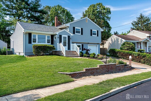 15 Crassas St, Old Bridge, NJ 08879 - split level home with a chimney, a garage, a front lawn, and driveway