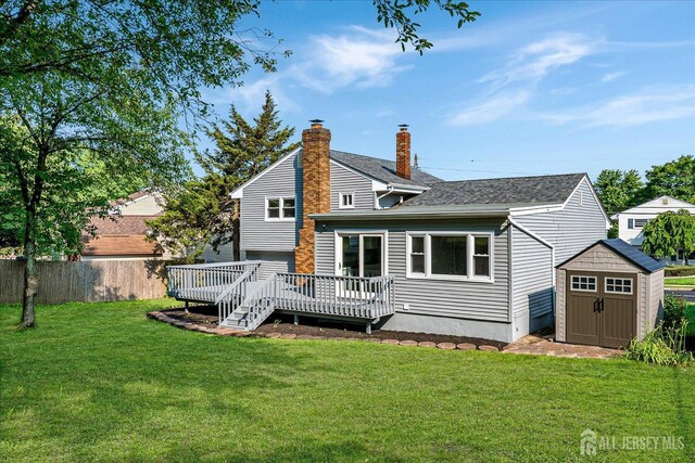 15 Crassas St, Old Bridge, NJ 08879 - rear view of property featuring a shed, a deck, a chimney, and a shingled roof