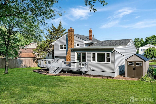 15 Crassas St, Old Bridge, NJ 08879 - rear view of property featuring a storage shed, a wooden deck, a chimney, and roof with shingles