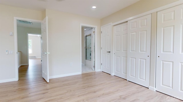 414-D Andover Dr, Monroe, NJ 08831 - unfurnished bedroom with light wood-type flooring, a baseboard radiator, baseboards, a closet, and ensuite bathroom
