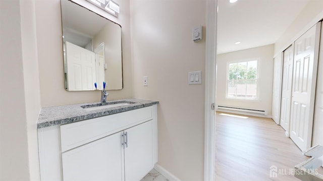 414-D Andover Dr, Monroe, NJ 08831 - bathroom with baseboard heating, baseboards, vanity, recessed lighting, and wood finished floors