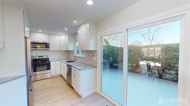 414-D Andover Dr, Monroe, NJ 08831 - kitchen with stainless steel appliances, backsplash, light stone countertops, white cabinets, and a sink