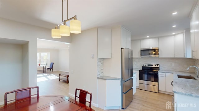 414-D Andover Dr, Monroe, NJ 08831 - kitchen with stainless steel appliances, a sink, tasteful backsplash, light wood-style flooring, and recessed lighting