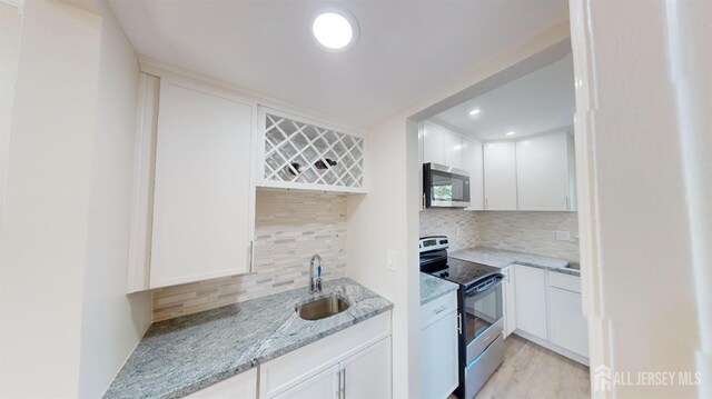 414-D Andover Dr, Monroe, NJ 08831 - kitchen with stainless steel appliances, a sink, decorative backsplash, and white cabinetry