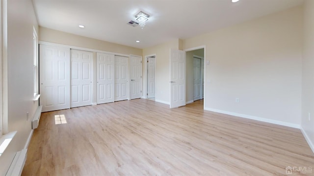 414-D Andover Dr, Monroe, NJ 08831 - unfurnished bedroom featuring baseboards, light wood finished floors, recessed lighting, and two closets