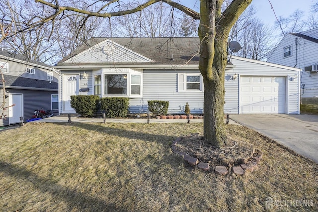 ranch-style house featuring concrete driveway, an attached garage, and a front yard