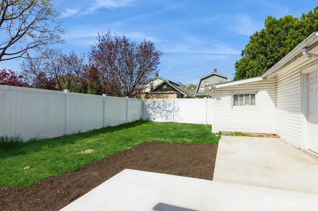 view of yard featuring a patio area and a fenced backyard
