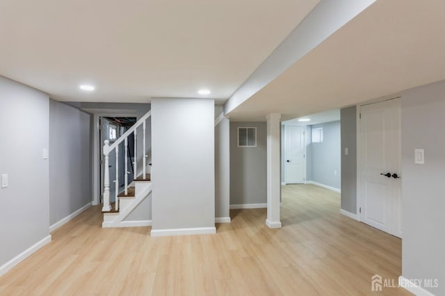 finished below grade area with wood finished floors, stairs, visible vents, baseboards, and recessed lighting